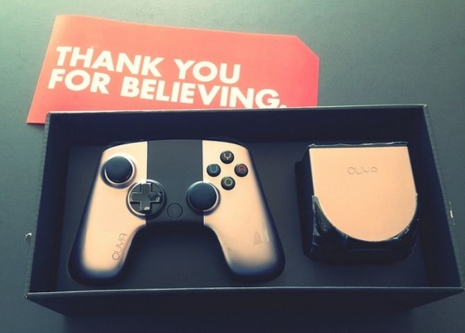 An Ouya console and controller in their original case